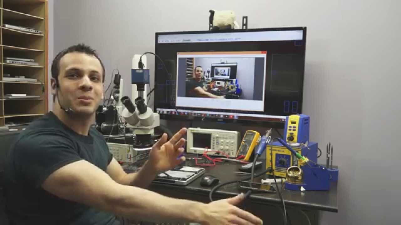 MacBook logic board repair in progress under microscope