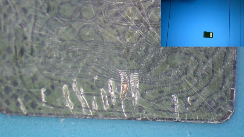 MicroSD card under microscope during initial damage assessment